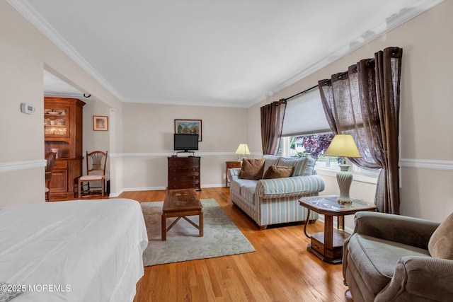 bedroom featuring crown molding and light wood-style flooring