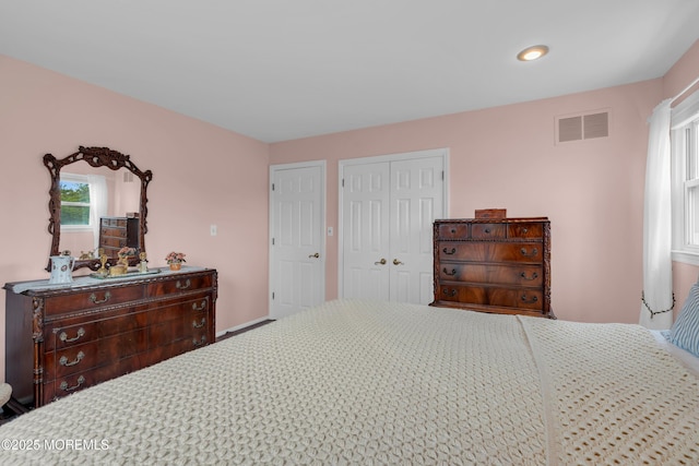bedroom featuring multiple windows, recessed lighting, a closet, and visible vents