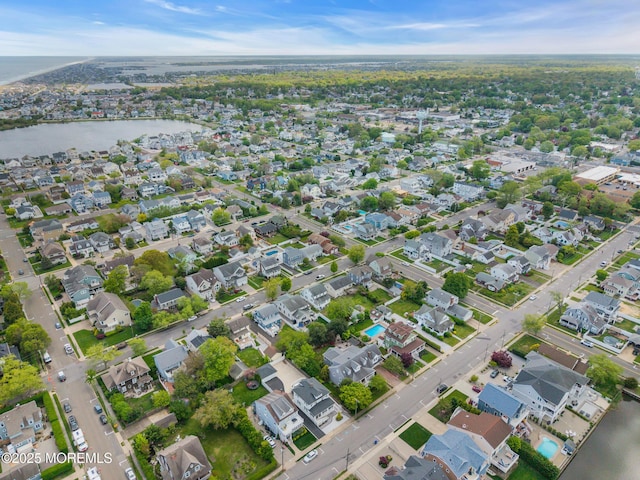 aerial overview of property's location with a nearby body of water and nearby suburban area