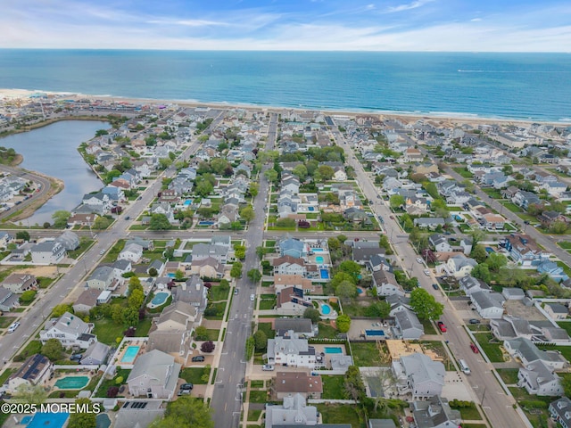 aerial overview of property's location with a large body of water and nearby suburban area