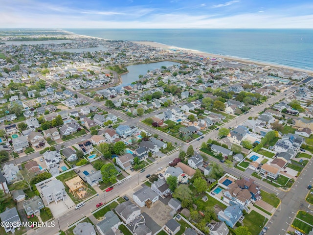 aerial view of property's location with a large body of water and nearby suburban area