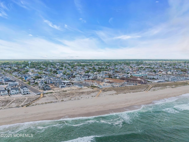 aerial view of residential area with waterfront with a beach