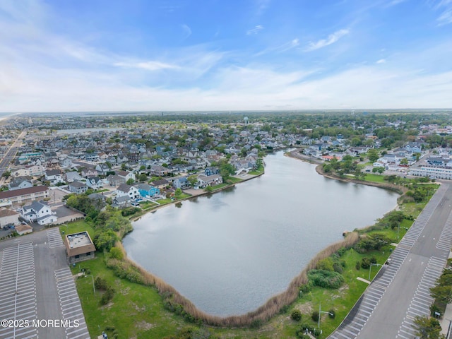 view of property location with a large body of water and nearby suburban area