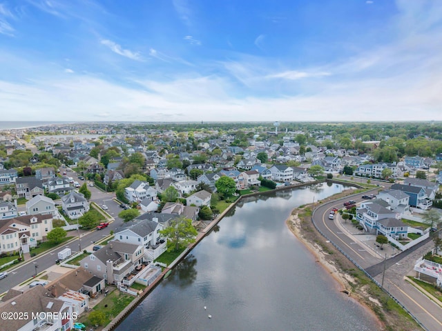 view of property location featuring a large body of water and nearby suburban area