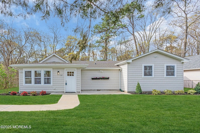 single story home featuring a shingled roof and a front lawn