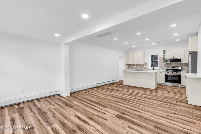 kitchen featuring a baseboard radiator, recessed lighting, stainless steel appliances, and light wood-style flooring