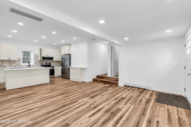 unfurnished living room featuring recessed lighting, visible vents, and light wood-type flooring