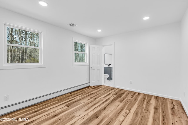 spare room with recessed lighting, light wood-style floors, visible vents, and baseboard heating