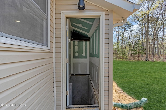 doorway to property with a yard