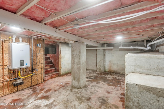 unfinished below grade area featuring tankless water heater and stairs