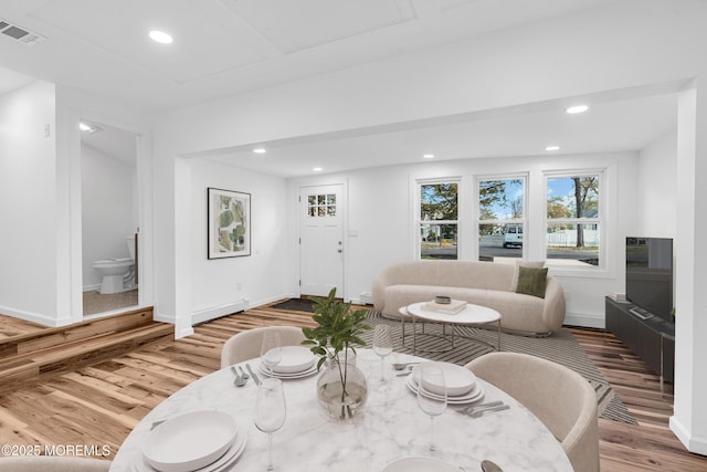interior space with baseboards, wood finished floors, visible vents, and recessed lighting