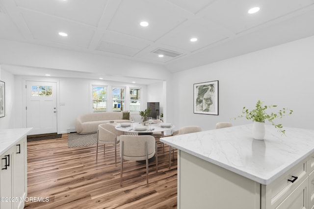 living room with recessed lighting, light wood-style flooring, and coffered ceiling