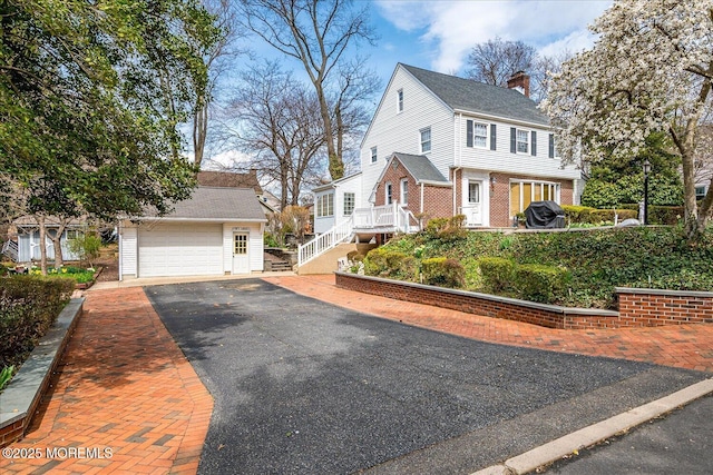 42 Pershing Ave, Sayreville Boro, NJ 08872 - view of front of property featuring an outbuilding, a chimney, a garage, and brick siding