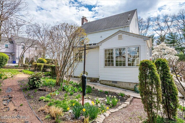 42 Pershing Ave, Sayreville Boro, NJ 08872 - view of home's exterior with a chimney and roof with shingles