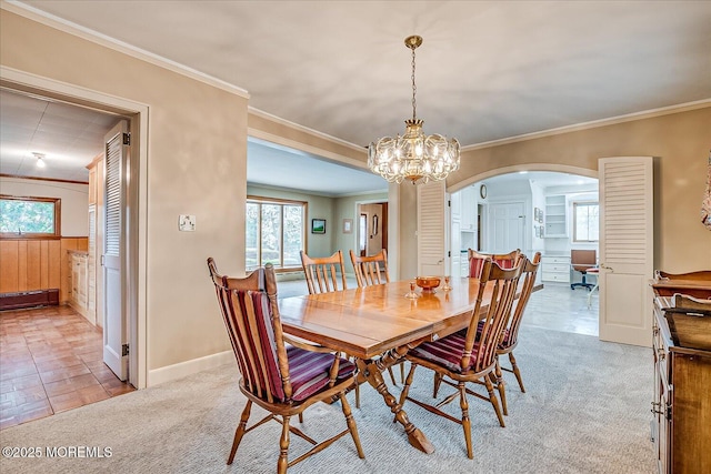 42 Pershing Ave, Sayreville Boro, NJ 08872 - dining area featuring arched walkways, healthy amount of natural light, a chandelier, ornamental molding, and carpet