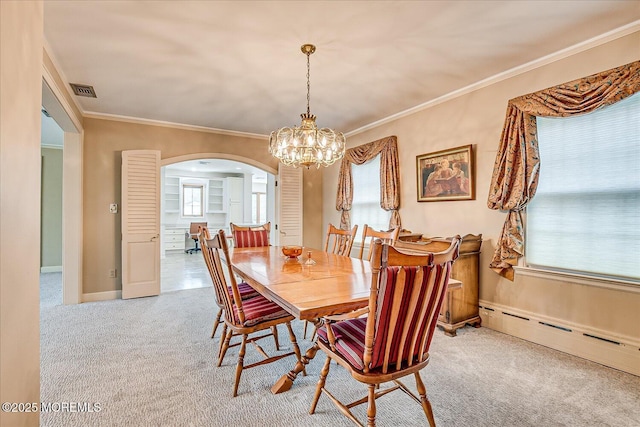 42 Pershing Ave, Sayreville Boro, NJ 08872 - dining space featuring arched walkways, a baseboard radiator, carpet, a chandelier, and crown molding