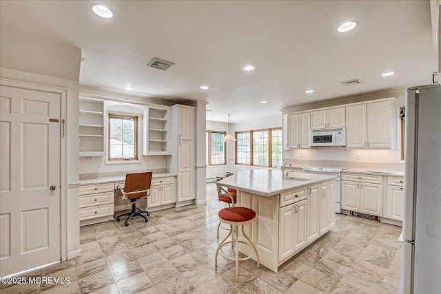 42 Pershing Ave, Sayreville Boro, NJ 08872 - kitchen featuring white appliances, light countertops, a kitchen breakfast bar, built in desk, and recessed lighting