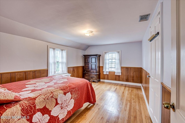42 Pershing Ave, Sayreville Boro, NJ 08872 - bedroom featuring wainscoting, light wood finished floors, multiple windows, wooden walls, and lofted ceiling