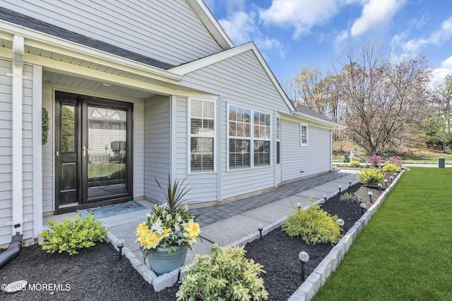 property entrance with a yard