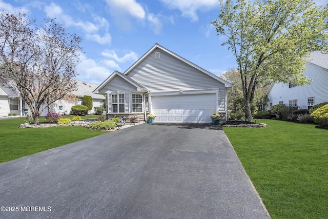 single story home featuring a front lawn, driveway, and a garage