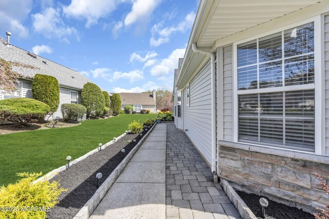 view of side of property featuring a lawn