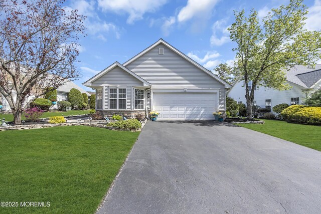 ranch-style home featuring stone siding, driveway, a garage, and a front yard