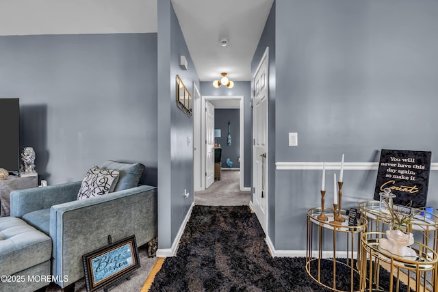 hallway with carpet and baseboards