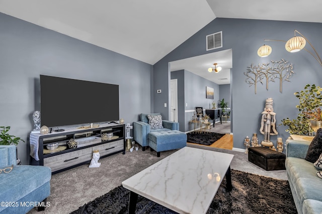 carpeted living room featuring visible vents and high vaulted ceiling