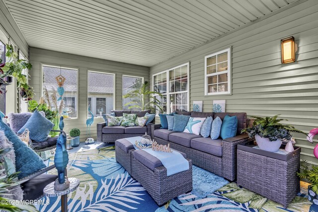 sunroom / solarium featuring an outdoor living space