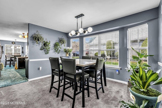 carpeted dining room with a healthy amount of sunlight and a notable chandelier