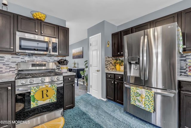 kitchen featuring dark brown cabinets, stainless steel appliances, decorative backsplash, and light colored carpet