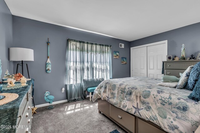 carpeted bedroom with a closet, baseboards, and visible vents
