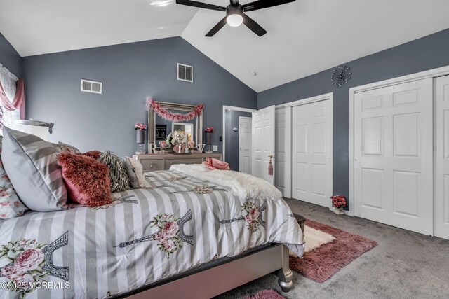 carpeted bedroom with high vaulted ceiling, a ceiling fan, multiple closets, and visible vents