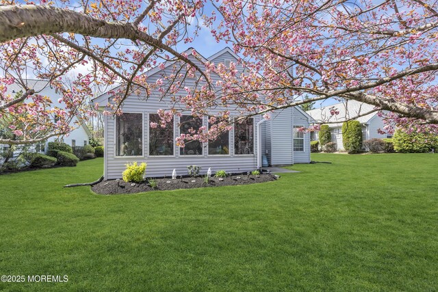 back of house with a yard