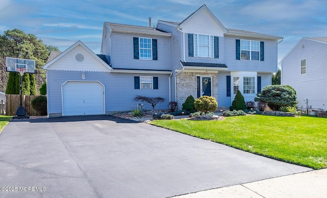 view of front of property with a front yard, an attached garage, fence, and driveway
