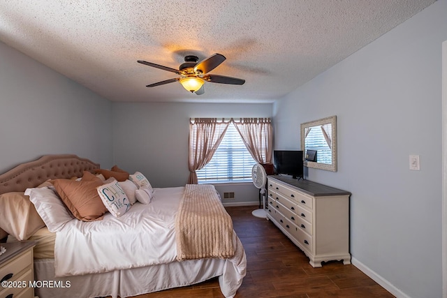 bedroom with visible vents, baseboards, ceiling fan, a textured ceiling, and dark wood-style floors