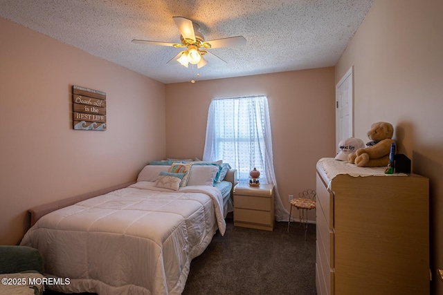 bedroom featuring dark carpet, a textured ceiling, and a ceiling fan