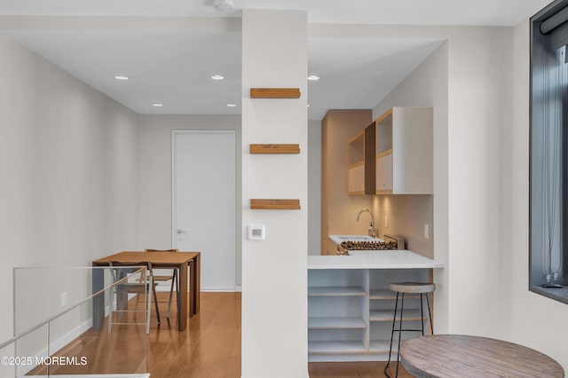 601 Bangs Ave Unit 1107, Asbury Park, NJ 07712 - kitchen with a sink, light wood-type flooring, baseboards, recessed lighting, and open shelves