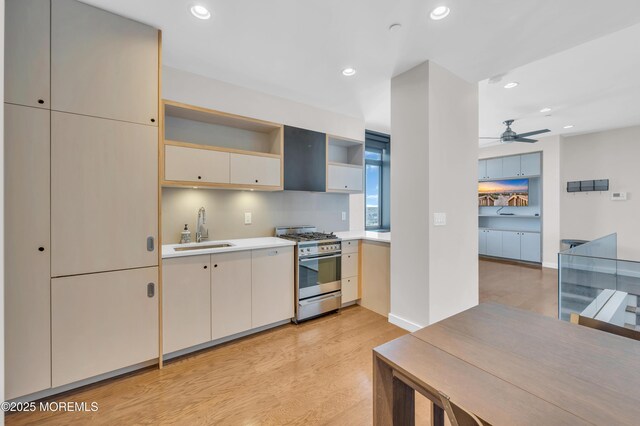 601 Bangs Ave Unit 1107, Asbury Park, NJ 07712 - kitchen featuring a sink, light wood-type flooring, gas range, light countertops, and recessed lighting