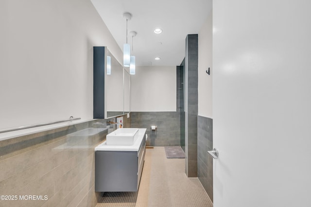 601 Bangs Ave Unit 1107, Asbury Park, NJ 07712 - full bath with tile patterned flooring, a wainscoted wall, double vanity, a sink, and tile walls