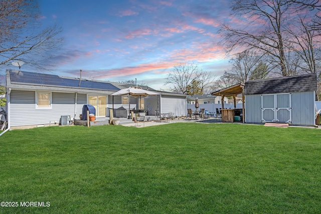 view of yard with a patio area, an outdoor structure, central air condition unit, and a storage unit