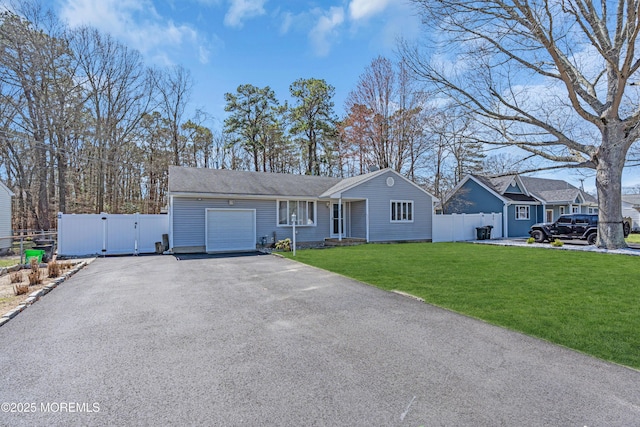 ranch-style home featuring a garage, aphalt driveway, fence, a front lawn, and a gate