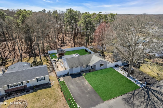 drone / aerial view featuring a wooded view