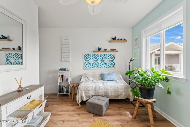 bedroom with baseboards and light wood-style flooring