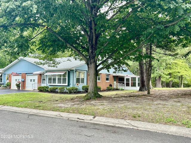 20 Lexington Dr Unit B, Whiting, NJ 08759 - view of front of property featuring brick siding, a garage, driveway, and a front lawn