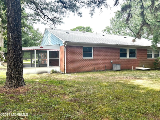 20 Lexington Dr Unit B, Whiting, NJ 08759 - back of property featuring a sunroom, brick siding, a yard, and a shingled roof