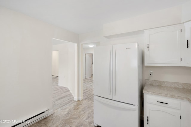 20 Lexington Dr Unit B, Whiting, NJ 08759 - kitchen featuring freestanding refrigerator, a baseboard heating unit, white cabinetry, and light countertops