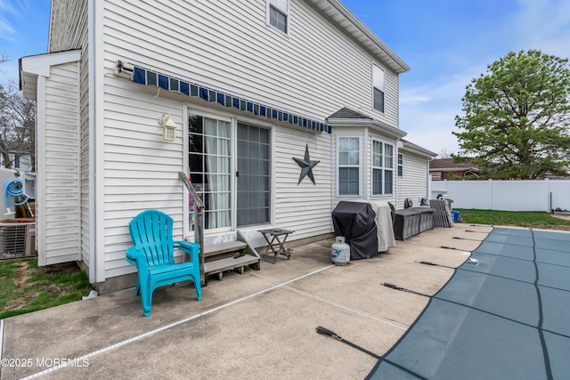 view of patio / terrace with grilling area, central AC, and fence