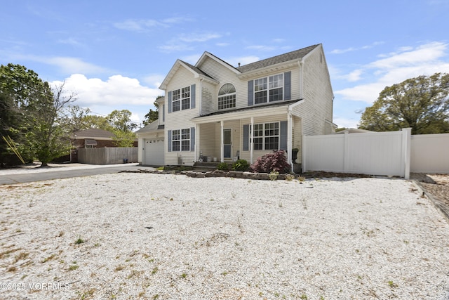 4 Frankies Ln, Toms River, NJ 08753 - traditional-style home featuring fence, a porch, concrete driveway, and a garage