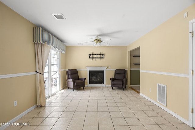 4 Frankies Ln, Toms River, NJ 08753 - living area featuring a glass covered fireplace, ceiling fan, light tile patterned flooring, and baseboards
